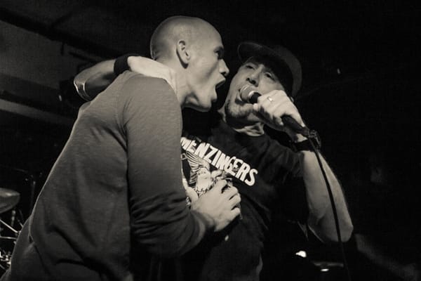 Kelly Slater dropping on stage to sink "Bro-Hymm" with Pennywise's Jim Lindberg.