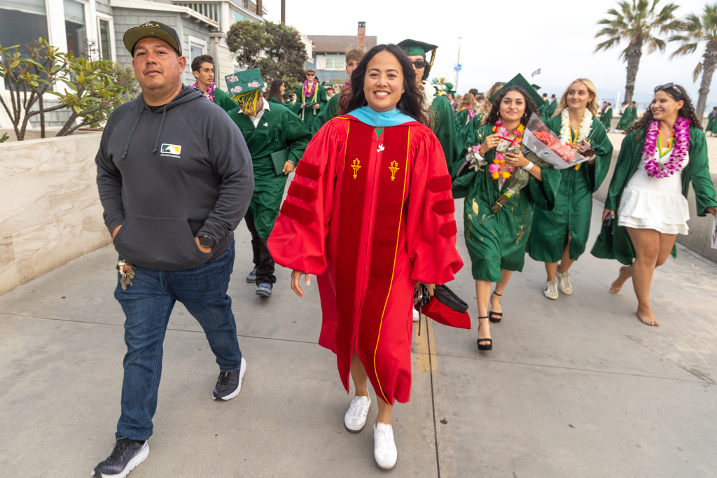Mira Costa Principal Jennifer Huynh leads the Class of 2025 on the traditional Strand walk from Hermosa Beach to the Manhattan Beach pier. Photo by Kevin Cody